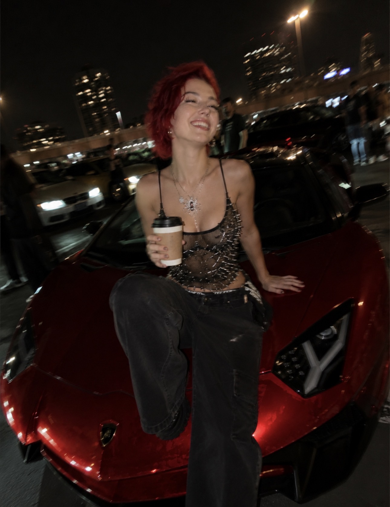 Alice Kwong with coffee beside a car in the city