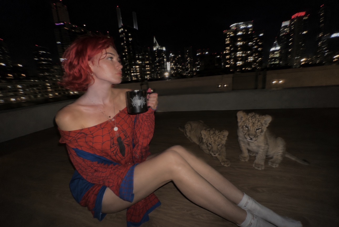 Alice Kwong in a red suit on a city rooftop