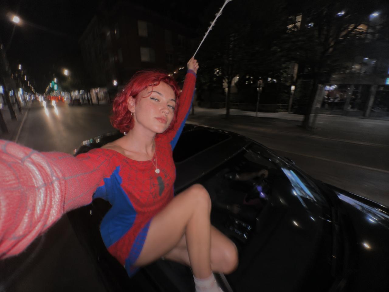 Alice Kwong in a spider-inspired look on a car at night